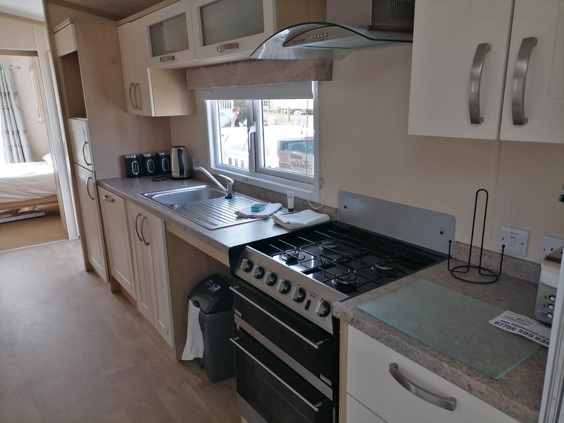 A kitchen with a stove and sink in it