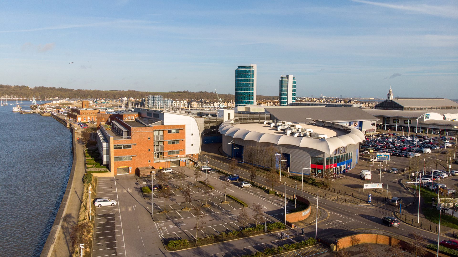 A parking lot with many buildings in the background